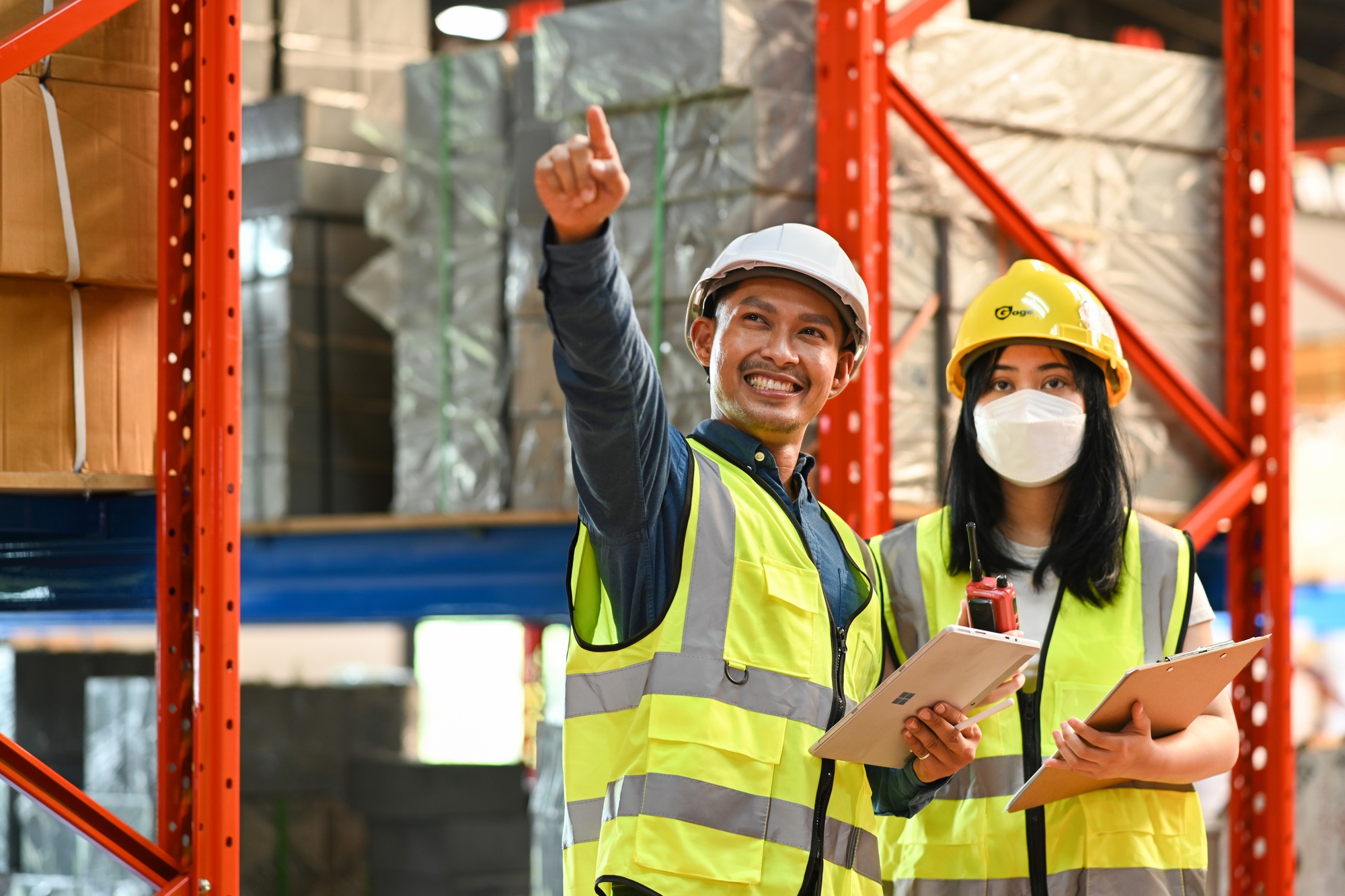Image of male and female workers working together in retail warehouse.
