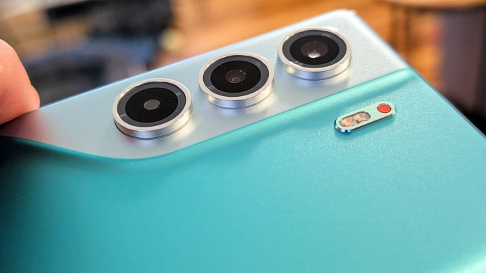 Close-up of the rear camera module of the TECNO Camon 40 Pro 5G smartphone, featuring three circular lenses and a flash, set against a light blue matte finish.