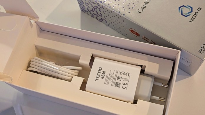 An unboxed TECNO Camon 40 Pro 5G charger with a USB-C cable and adapter, displayed in a white packaging with brand logos.