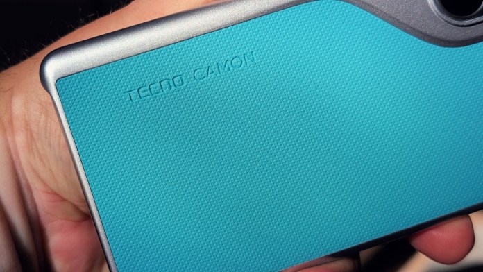 Close-up of the back of a TECNO Camon smartphone showcasing its textured turquoise finish and brand logo.