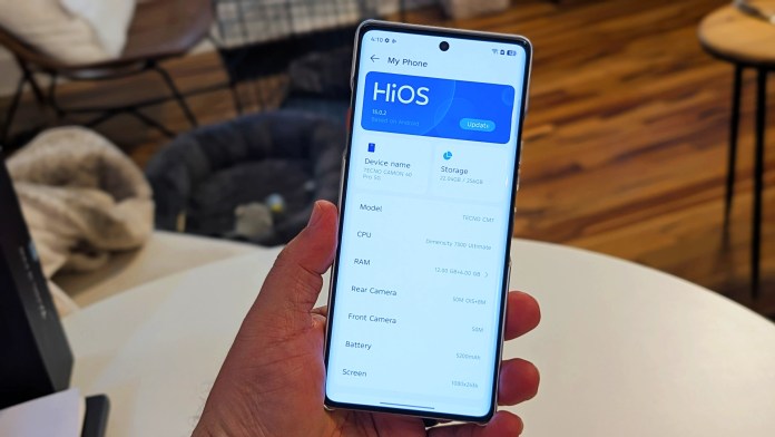 A person holding a TECNO Camon 40 Pro 5G smartphone displaying the HiOS interface, showing device specifications such as model, CPU, RAM, and storage details.