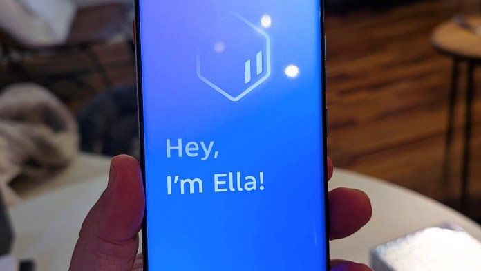 A close-up view of the TECNO Camon 40 Pro 5G smartphone displaying the introduction screen for the AI assistant 'Ella' with a blue background and the text 'Hey, I’m Ella!'