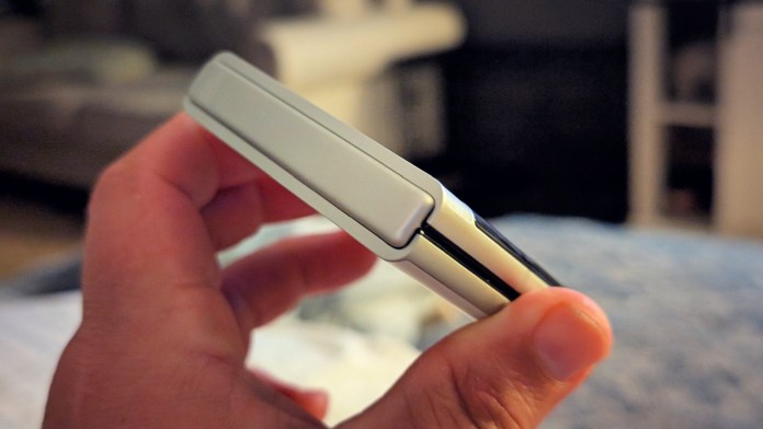 A close-up of a person holding the Motorola Razr 2025 in a folded position, highlighting its compact design and sleek finish.