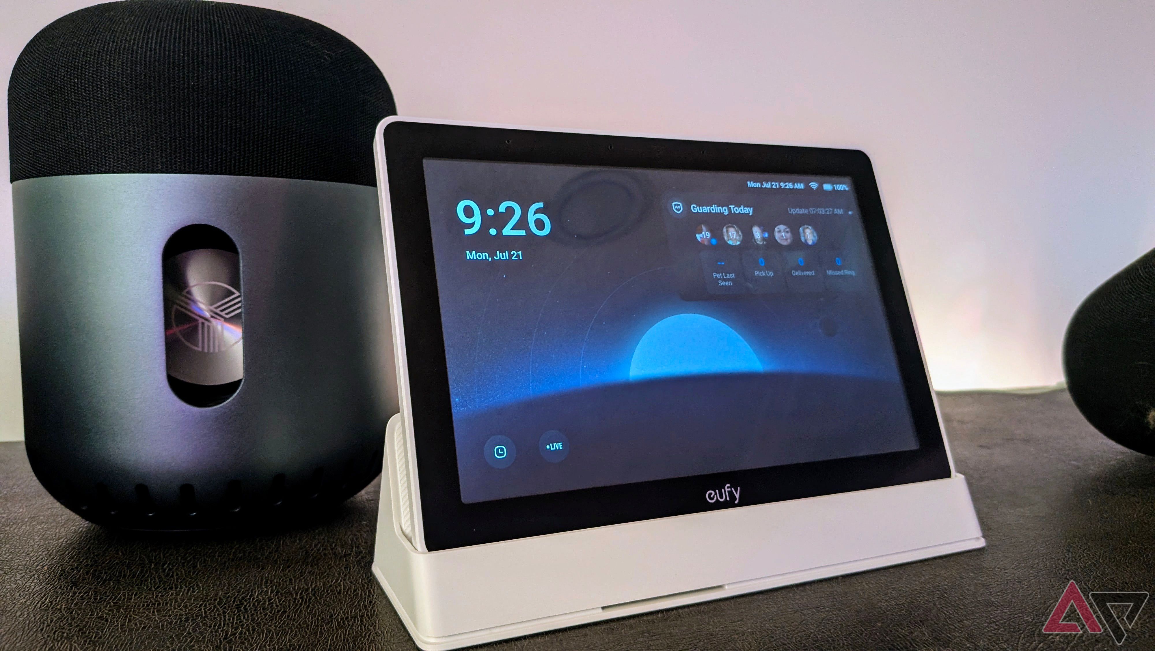 Eufy Smart Display E10 in its dock beside a Bluetooth speaker