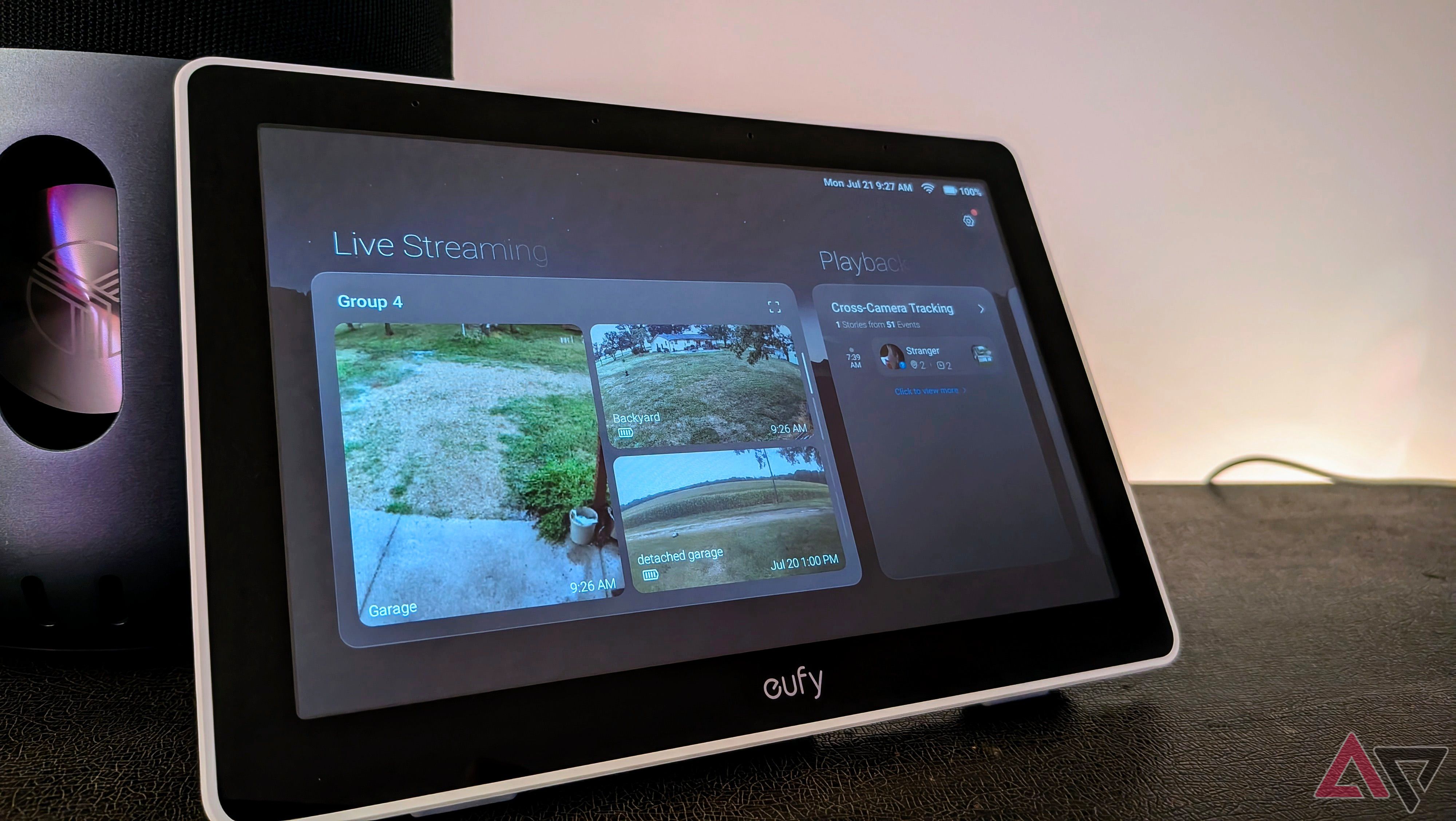 Eufy Smart Display E10 showing the home screen leaning against a speaker