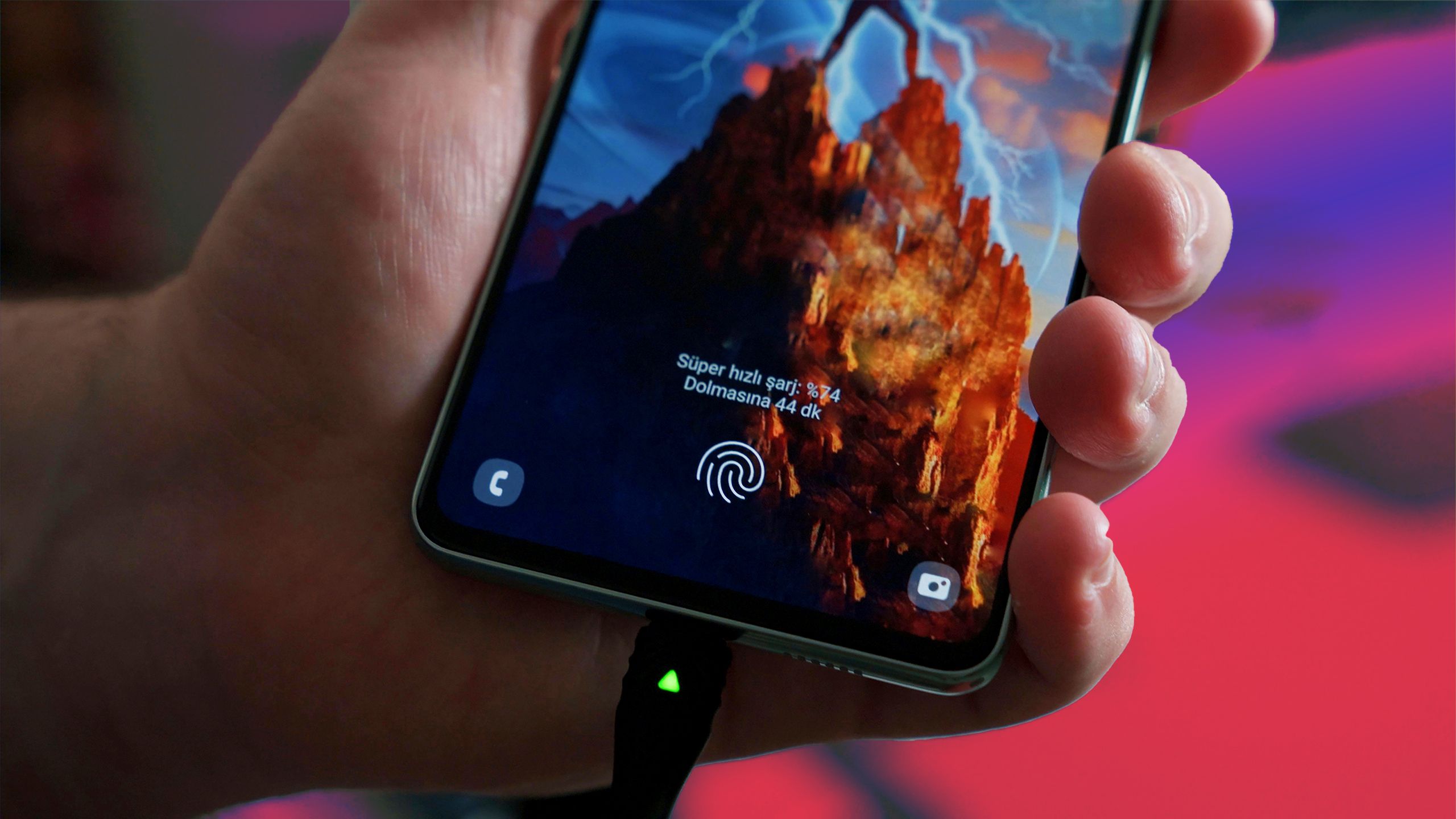 Hand holding a phone while charger is connected