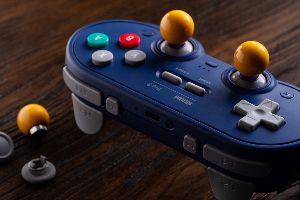 The ball-top stick caps match each controller's theme. 