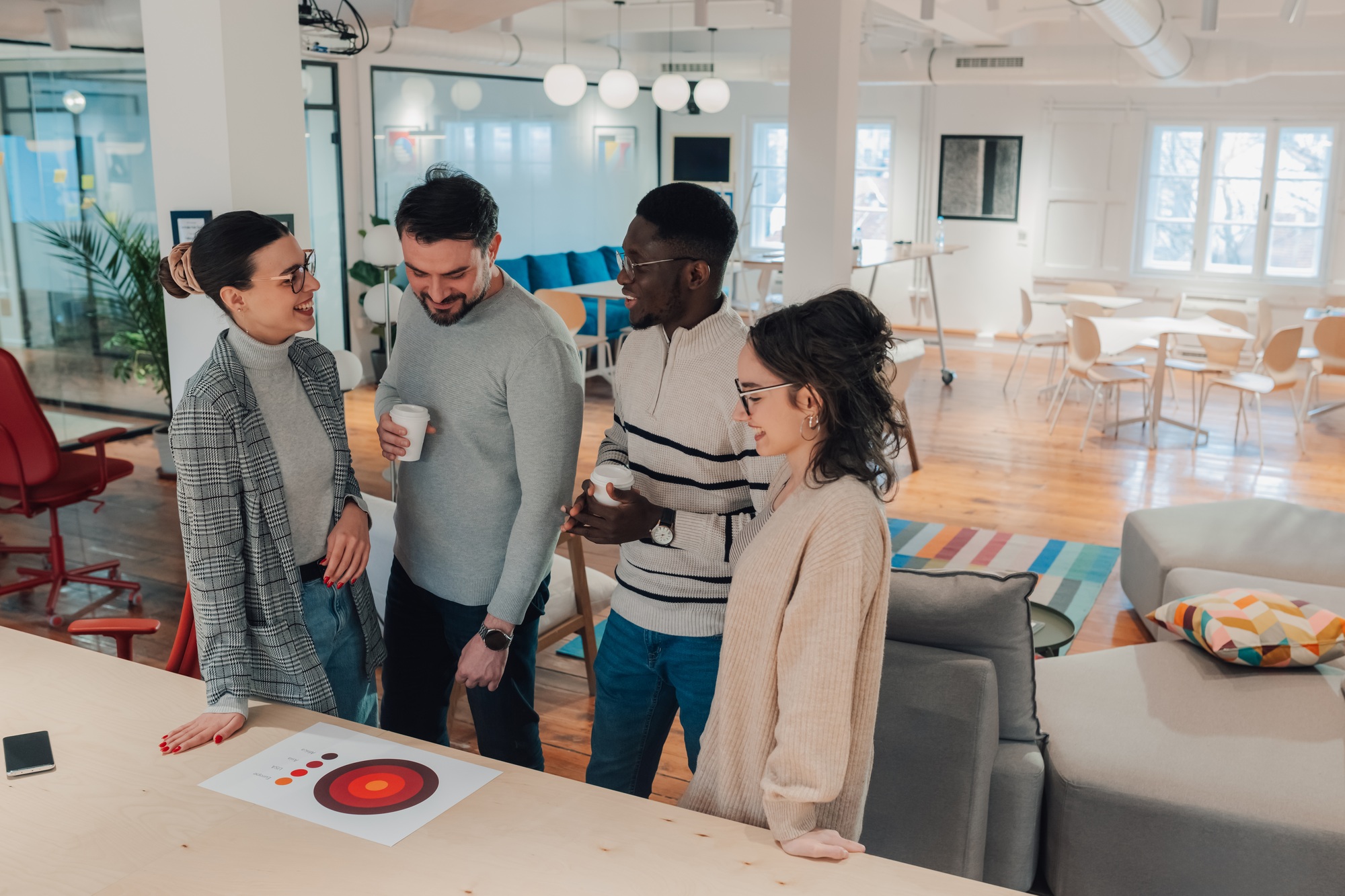 Marketing professionals discussing target market strategy in modern office