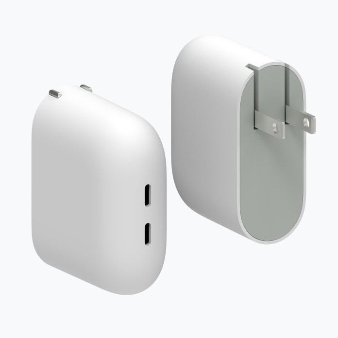 A dual-port USB-C wall charger with a minimalistic white design, featuring two USB-C ports on the front and folding prongs on the back.