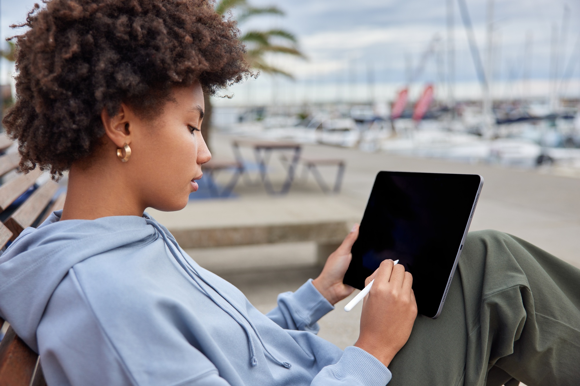 Experienced graphic designer draws sketches on digital tablet uses stylus creats logo design wears c