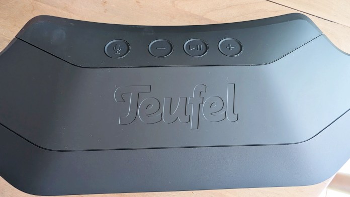 Close-up of the top panel of the Teufel ROCKSTER CROSS Bluetooth speaker showcasing its buttons and embossed logo.
