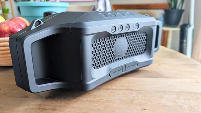 Side view of the Fender x Teufel ROCKSTER CROSS Bluetooth speaker, showcasing its rugged design, grippy rubber exterior, and mesh grille.