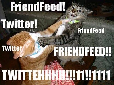 A meme showing two cats fighting, overlaid with text labeling one as “Twitter” and the other as “FriendFeed,” suggesting a rivalry between social platforms.