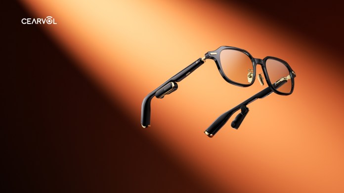 Cearvol Lyra smart glasses designed for hearing enhancement, featuring a sleek black frame with gold accents, illuminated against a warm gradient background.
